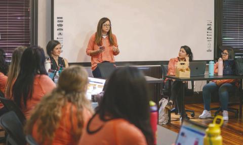 At the recent Reach Impact Day, Reach CEO Kelly Trace (standing) goes over the new branding effort with Healthy Start of Osceola County Executive Director Kerri Stephen and the team. (Photos/Reach)