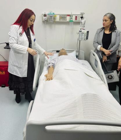 NUC University Kissimmee Director of Nursing Meghan Harvey explains how simulation lab functions operate at Thursday's open house. (Photo/Ming Henry)