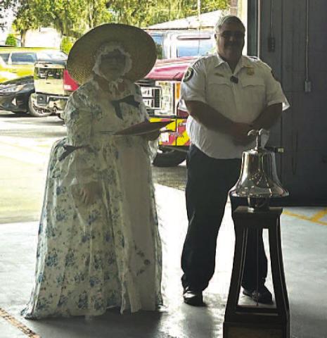 NSDAR Joshua Stevens Regent Kim Tennison and St. Cloud Deputy Fire Chief Richard Tonks at the ceremonial ringing of the bell 237 times to celebrate Constitution Week held Sept. 17-23. PHOTO/MING HENRY