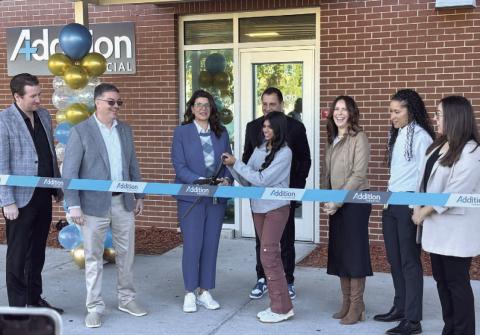 Melinee Patayya, student head teller in the Osceola High Addition Financial branch, helped OHS Principal Elizabeth Kennedy cut the ceremonial ribbon last week on the new banking location. PHOTO/DAVID CHIVERS