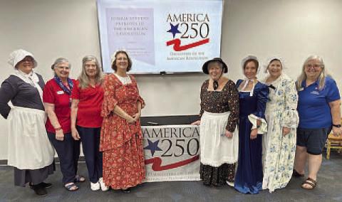 Claudia Dundas, Nona Osha, Lynn Cameron, Lori Swaby, Ginny Brown, Elena Oleske, Kim Tennison and Susie Smith, in traditional American Revolution garb, presented stories of their patriot ancestors at Saturday’s “America 250” event at the St. Cloud Veterans library. SUBMITTED PHOTO