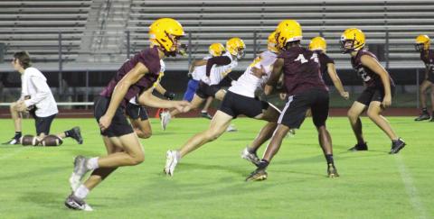 The St. Cloud Bulldogs began fall football practice the first moment they could — 12:01 a.m. Monday — and worked out under the practice field lights. PHOTO/LINDSEY TELLEZ