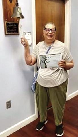 Awilda Donato, Case Management Director at the Osceola Council on Aging, rings the bell at her doctor’s office signifying her breast cancer treatments were over. SUBMITTED PHOTO