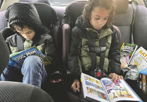 Jearene Webb’s twins enjoying Dogman books on the go. (Submitted Photo)