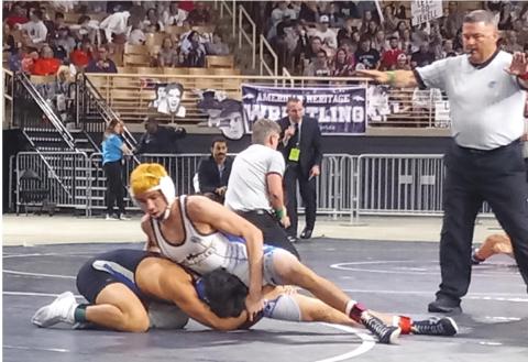 Cooper Haase (top) gets ready to turn Riverview’s Nikolas Hernandez in the Class 3A, 138-pound finals of the FHSAA state wrestling tournament to win his third state title. PHOTO/J. DANIEL PEARSON
