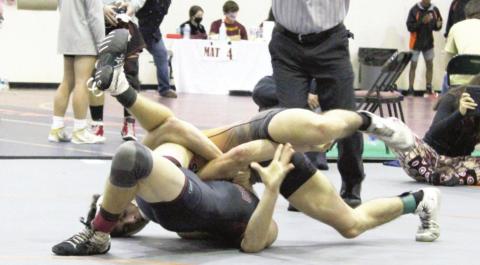 Harmony’s JC McNichols (top) pins an opponent during the Bulldog Classic. McNichols, wrestling in the 132-pound weight class, and teammate Aiden Poe (120), each went 7-0 in the two-day event as the Harmony finished second in the event. Photo courtesy of becky mcnichols