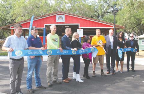 City of Kissimmee officials cut the ceremonial ribbon on Lancaster Ranch Park Tuesday, which includes a new location for longtime area attraction Green Meadows Petting Farm. PHOTO/KEN JACKSON