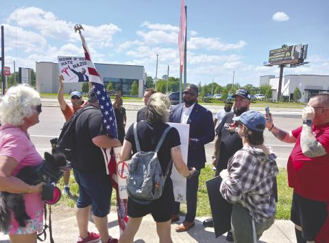 U.S. Rep. and gubernatorial hopeful Byron Donalds listened to protesters concerns at Saturday’s rally. PHOTO/LARRY GRIFFIN