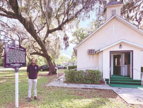 Rev. Marcus Stovall, with the historical marker that was placed last year at St. Luke Missionary Baptist Church. (Photos/Debbie Daniel)