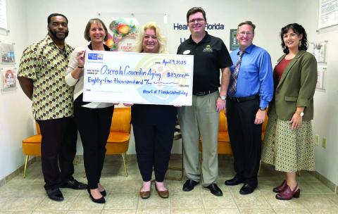 Members of the Heart of Florida United Way present a check for $85,000 to Wendy Coschignano-Ford, president/CEO of the Osceola Council on Aging. (Photo/Osceola Council on Aging)