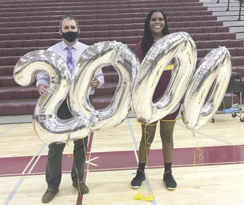 Eno Inyang and Head Coach Chad Ansbaugh hold up balloons commemorating Inyang’s 2,000 career points at St. Cloud High School. The second all-time leading scorer in the county, Inyang is headed for Clemson in the fall and is the Osceola News Gazette’s Player of the Year for 2020-21 PHOTO/ST. CLOUD HIGH SCHOOL