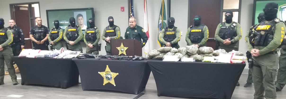 PHOTO/KEN JACKSON Osceola County Sheriff Marcos Lopez stands behind drugs and guns seized since July by officers now a part of the new Osceola Narcotics Investigation Bureau.