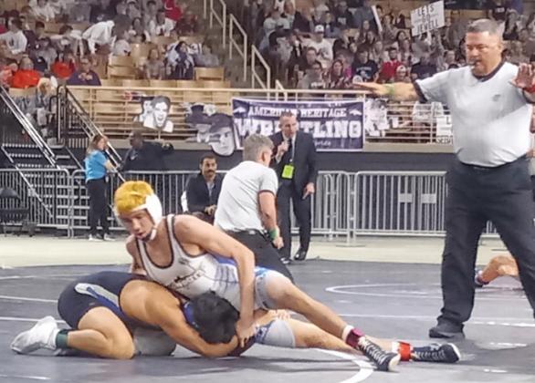 Osceola’s Cooper Haase (in white) works a move on Riverview’s Nikolas Hernandez in the Class 3A 138-pound state championship match at Osceola Heritage Park. Haase won with a pin for his third state title. PHOTO/J. DANIEL PEARSON