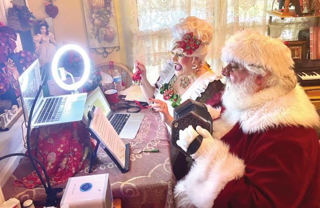 Santa and Mrs. Claus perform Jingle Bells while on a virtual call with kids in Kentucky. NEWS-GAZETTE PHOTO/BRIAN MCBRIDE