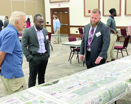 FDOT Project Manager Kevin Powell (with beard) goes over designs of the U.S. Highway 192 improvements, including what improved lanes and sidewalks will look like (pictured). PHOTOS/DAVID CHIVERS