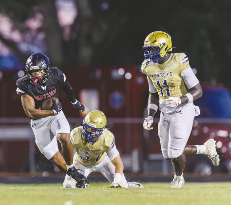 Osceola defenders Jason Lewis (11) and Colton Carter (21) try to bring down Gateway’s Honor Kim in Friday’s spring football jamboree. (Photo/Taylor McFee)