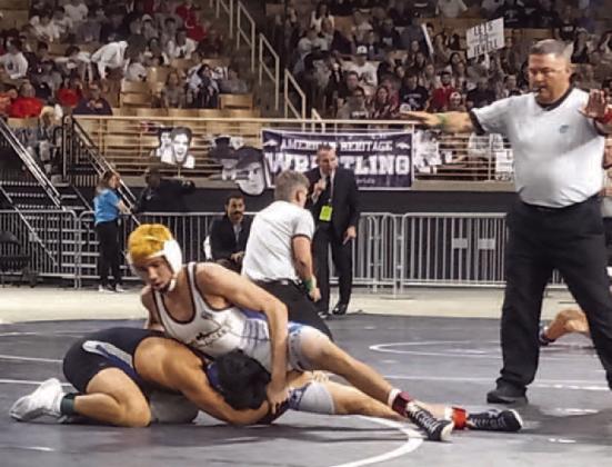 Osceola High’s Cooper Haase (white) works a move against Nikolas Hernandez during the 2022 FHSAA State championship final at 138 pounds on the way to another state title. PHOTO/J. DANIEL PEARSON