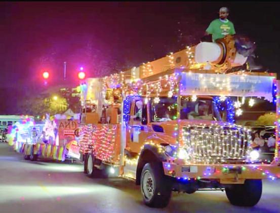 KUA trucks leading the festival of lights. PHOTO/CHRIS MILLER