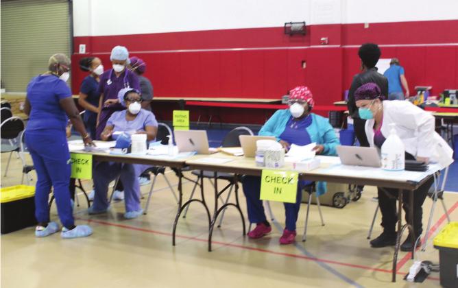 Staff awaits the opening of the monoclonal antibody clinic at the St. Cloud Civic Center on Sept. 7. PHOTO / KEN JACKSON