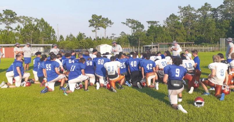 Head Coach Don Simon (center) talks to his team after a spring practice. NEWS-GAZETTE PHOTO/J DANIEL PEARSON