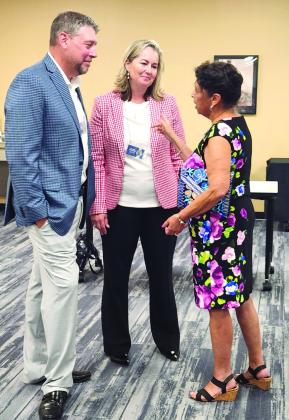 Dr. Ann Hembrook meets with former Osceola superintendent Melba Luciano at Monday’s event at Valencia College. PHOTOS/KEN JACKSON