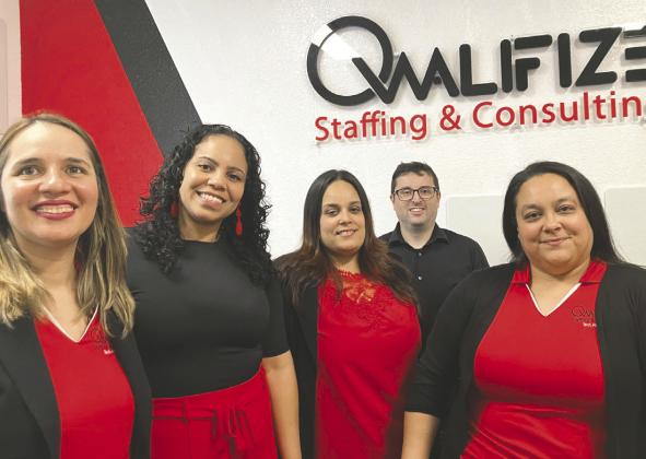 Kissimmee’s Lizbeth Walker (second from left) with her Qwalifize, LLC staff, was named Small Business Administration’s South Florida district Woman Business Owner of the Year. PHOTO/DAVID CHIVERS