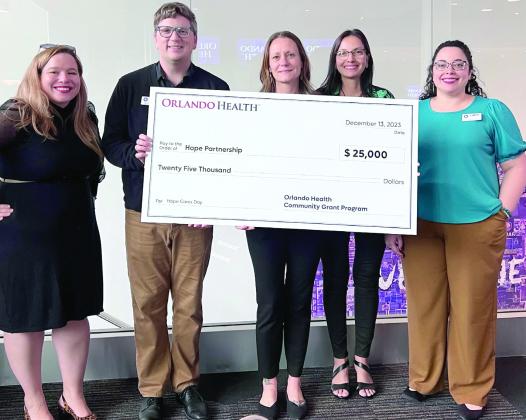 Hope Partnership team members proudly display their 2024 Orlando Health Grant check during award recognition last week in Orlando. Hope Partnership was one of two Osceola County community organizations and 18 overall to receive grants to further their work. PHOTO/HOPE PARTNERSHIP