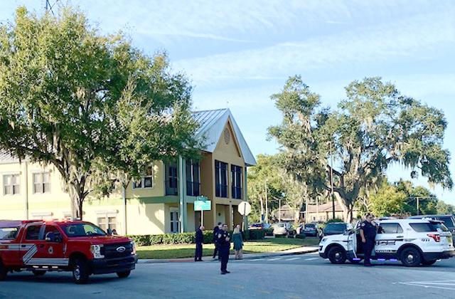 News-Gazette Photo/Brian McBride Kissimmee Police Department officers closed off part of the downtown area Tuesday morning to investigate a suspicious package found at city hall.