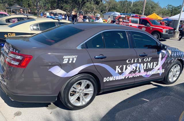 Photo/Kissimmee Police Department. The Ford Taurus that the Kissimmee Police Department rolled out says “Domestic Violence Awareness” and displays a purple ribbon.