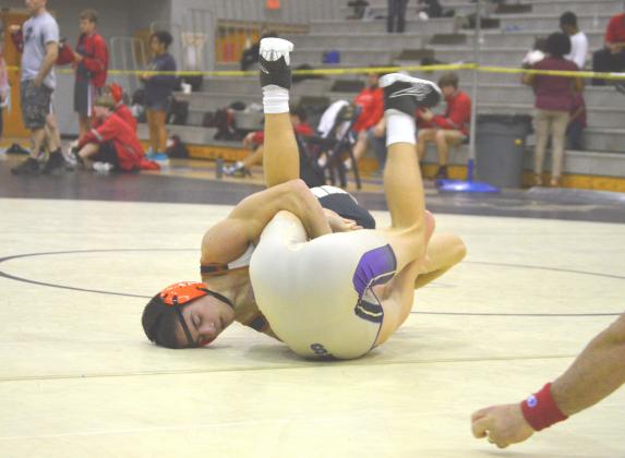 PHOTO COURTESY OF ANDIE HINMAN, HARMONY WRESTLING Harmony’s Jonathan McNichols pins Winter Springs’ David Deal in the 126-pound class.