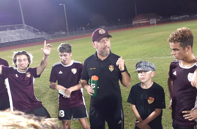 St. Cloud Head Coach Weylan Craig (center) talks to his team following Wednesday 3-0 win over Viera. PHOTO/J. DANIEL PEARSON