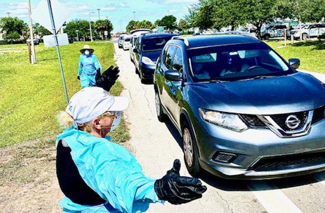 The line of cars waiting to get food stretches down the road. NEWS-GAZETTE PHOTO/BRIAN MCBRIDE