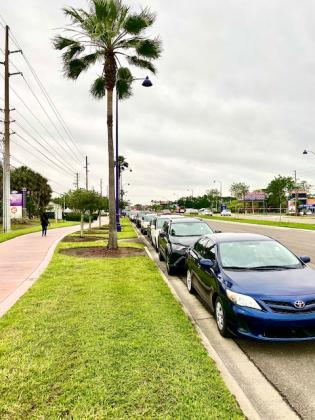 A line of cars stretches down U.S. 192 waiting for food. NEWS-GAZETTE PHOTO/BRIAN MCBRIDE