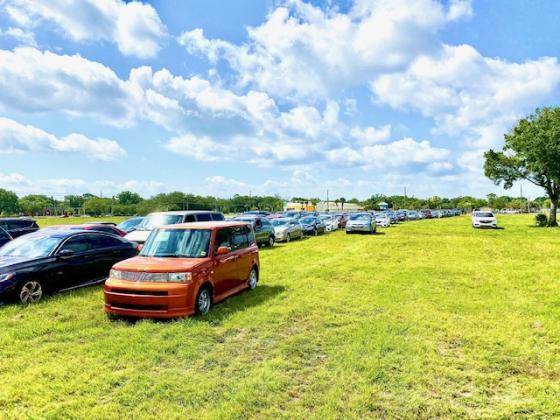 A sea of people in vehicles wait in a lot to get food. NEWS-GAZETTE PHOTO/BRIAN MCBRIDE