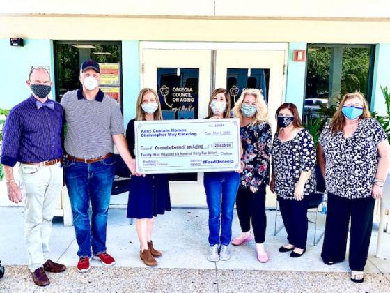 Representatives from Feed Osceola and the Osceola Council on Aging stand with a check for $23,635. The group will now start buying fresh produce from local farmers and gift cards from 24 area eateries for the council to distribute to those in need. NEWS-GAZETTE PHOTO/BRIAN MCBRIDE