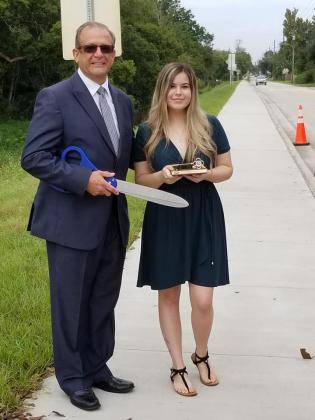 At the ribbon cutting ceremony, Mayor Nathan Blackwell presented a key to the city to Charity Best, who came to City Council when she was a senior at St. Cloud High School to ask for the sidewalk to be built.