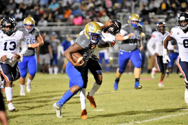 Osceola High running back Ja’Randy Swint (No. 5) breaks loose on a 18-yard touchdown run in Friday’s game with Tohopekaliga.   (Photo courtesy of Jana Stultz /Osceola High School)