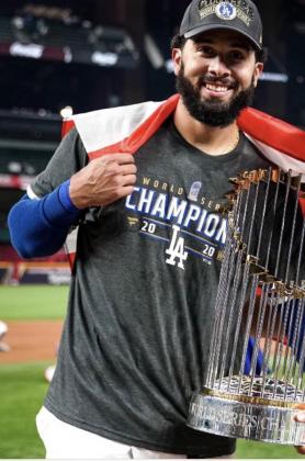 Former Kowboys infielder Edwin Rios poses with the World Series trophy. (Photo courtesy of Scott Birchler/Osceola High School)