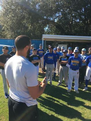 Edwin Rios (white shirt) gives pointers to the 2019 Osceola baseball team. (Photo courtesy Scott Birchler/Osceola High School)