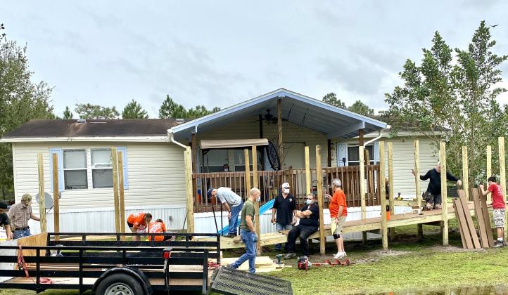 Volunteers work to build a 48-foot wheelchair ramp for a veteran and his wife in Holopaw. NEWS-GAZETTE PHOTO/BRIAN MCBRIDE