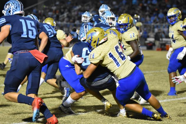Defensive End Anthony Famularo wraps up Newsome ball carrier Jack Arnone for no gain during Osceola’s 17-7 win on Friday.  Photo courtesy of Jana Stultz/Osceola High School)
