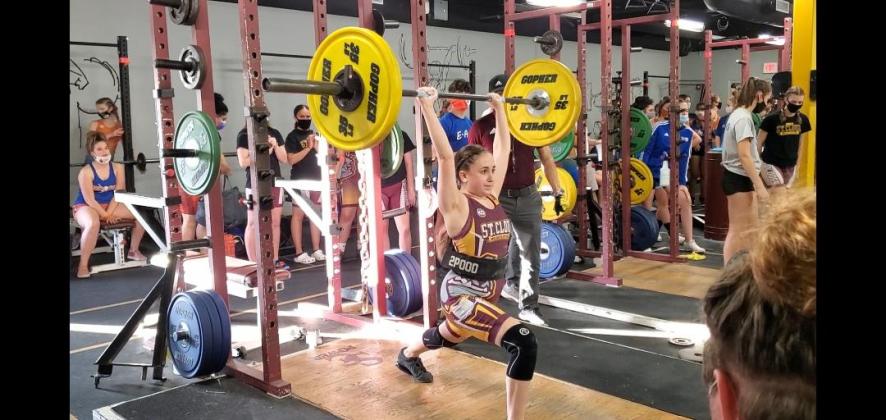 St. Cloud freshman Ashley Aun (110-pound class) is successful at her clean and jerk attempt of 120 pounds in a recent competition. Photo Courtesy of St. Cloud High School.
