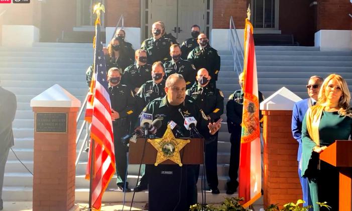 Osceola Sheriff Marco Lopez speaks during his swearing-in ceremony on Tuesday with his new admnistration behind him at the Osceola County Historic Courthouse. 
