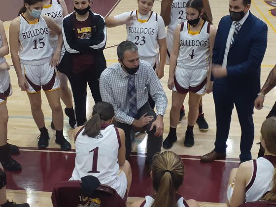 St. Cloud Head Coach Chad Ansbaugh (center) talks to his team during a third quarter timeout. The Lady Bulldogs had to rally from a six-point deficit to win the game and advance in the FHSAA 6-A state tournament. NEWS-GAZETTE PHOTO/J. DANIEL PEARSON