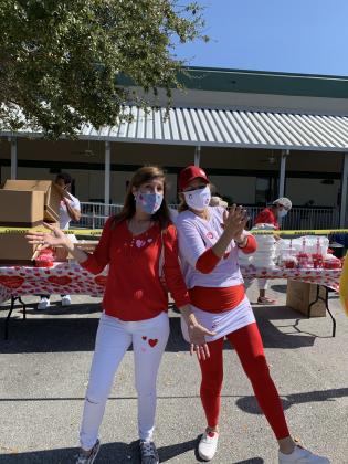 Wilda Belisle, senior vice president of Meals on Wheels at the Osceola Council on Aging, entertaining seniors at the Valentine's Day Drive-Through event. PHOTO/OSCEOLA COUNCIL ON AGING