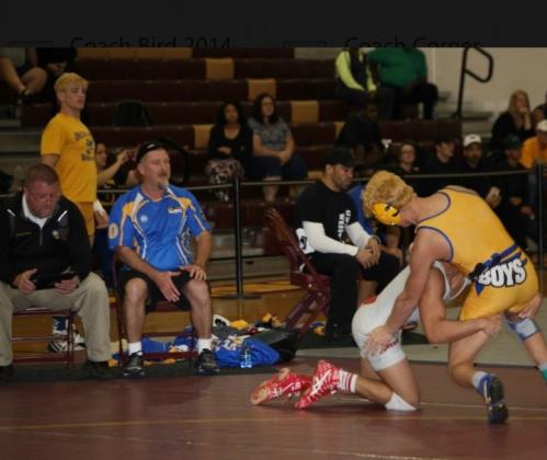  Jim Bird (center, blue shirt) has built a wrestling dynasty at Osceola High School in addition to being the school’s highly successful athletic director. Photo courtesy of Osceola High School.
