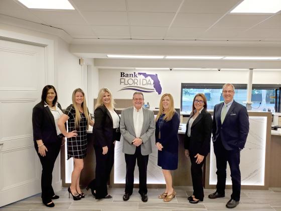 Bank Florida Market President Tom White, center, is pictured with staff at the bank location in Kissimmee.