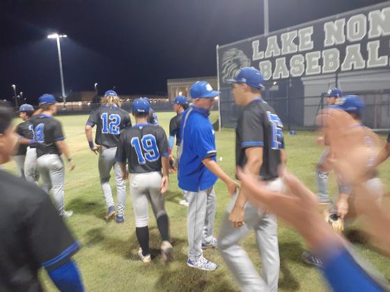 Osceola Head Coach Scott Birchler (center) congratulates starting catcher Edwin Melendez (15) following the Kowboys’ 5-1 win over Lake Nona on Wednesday night.