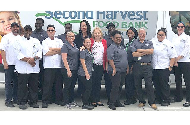 Nancy Brumbaugh and her staff at Second Harvest Food Bank of Central Florida stand outside one of the many trucks that deliver food throughout Central Florida. Photo courtesy of Second Harvest Food Bank