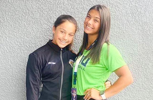 Cate Palmi (left) takes a few minutes to visit with older sister Allison at the Junior Olympics National Volleyball Championship in Las Vegas PHOTO/PALMI FAMILY